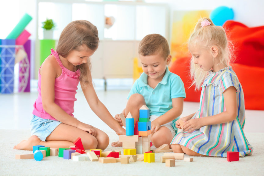 a group of children playing with toys