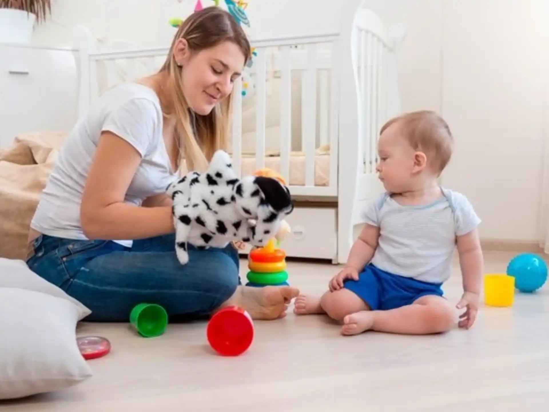 a person and a child playing with toys on the floor