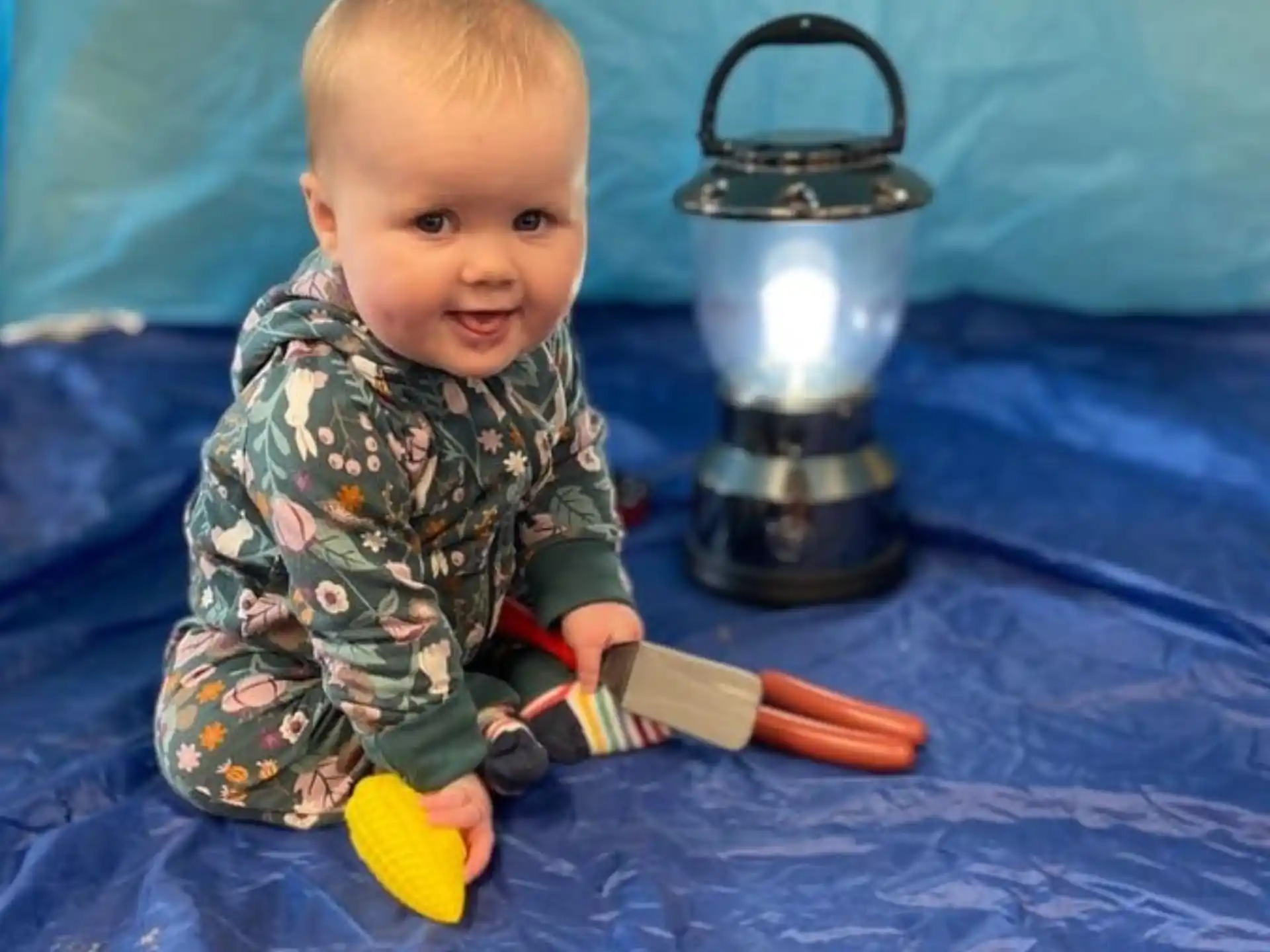 a baby holding a toy sword