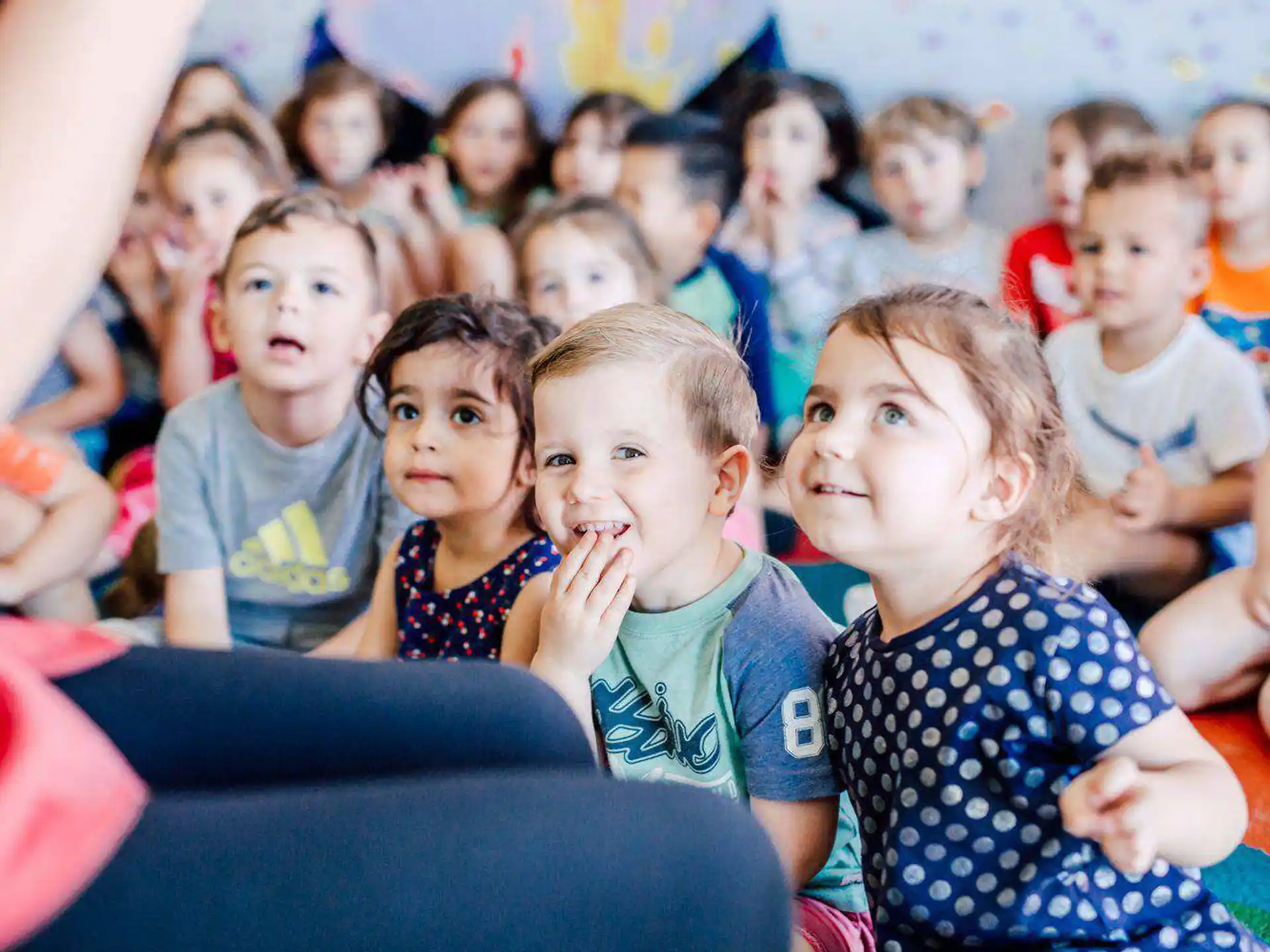 a group of children sitting in a classroom