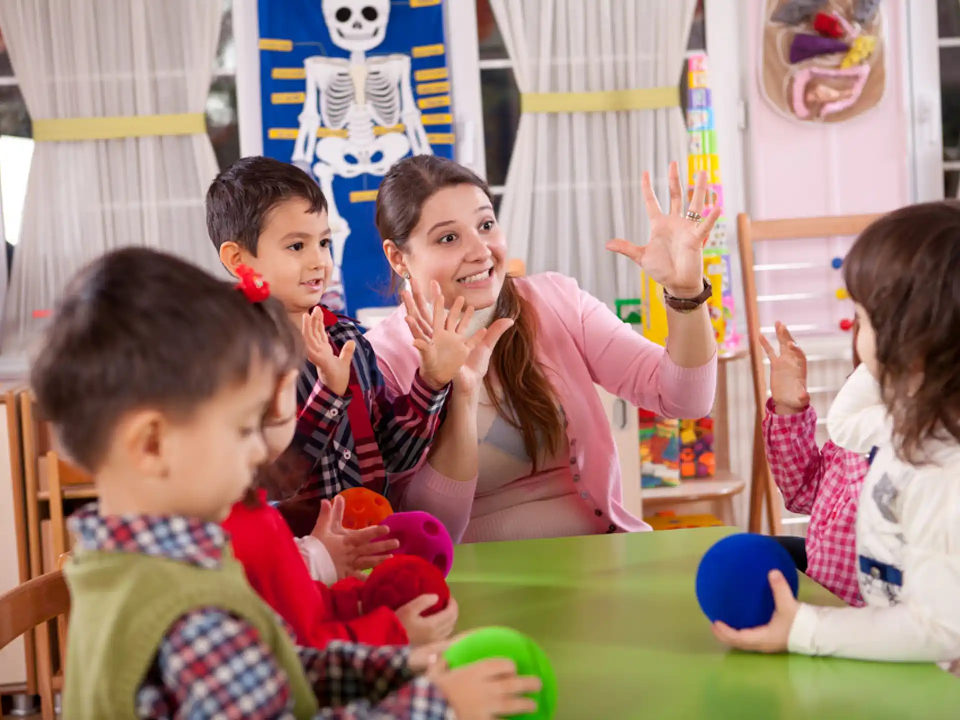 a person and several children sitting at a table