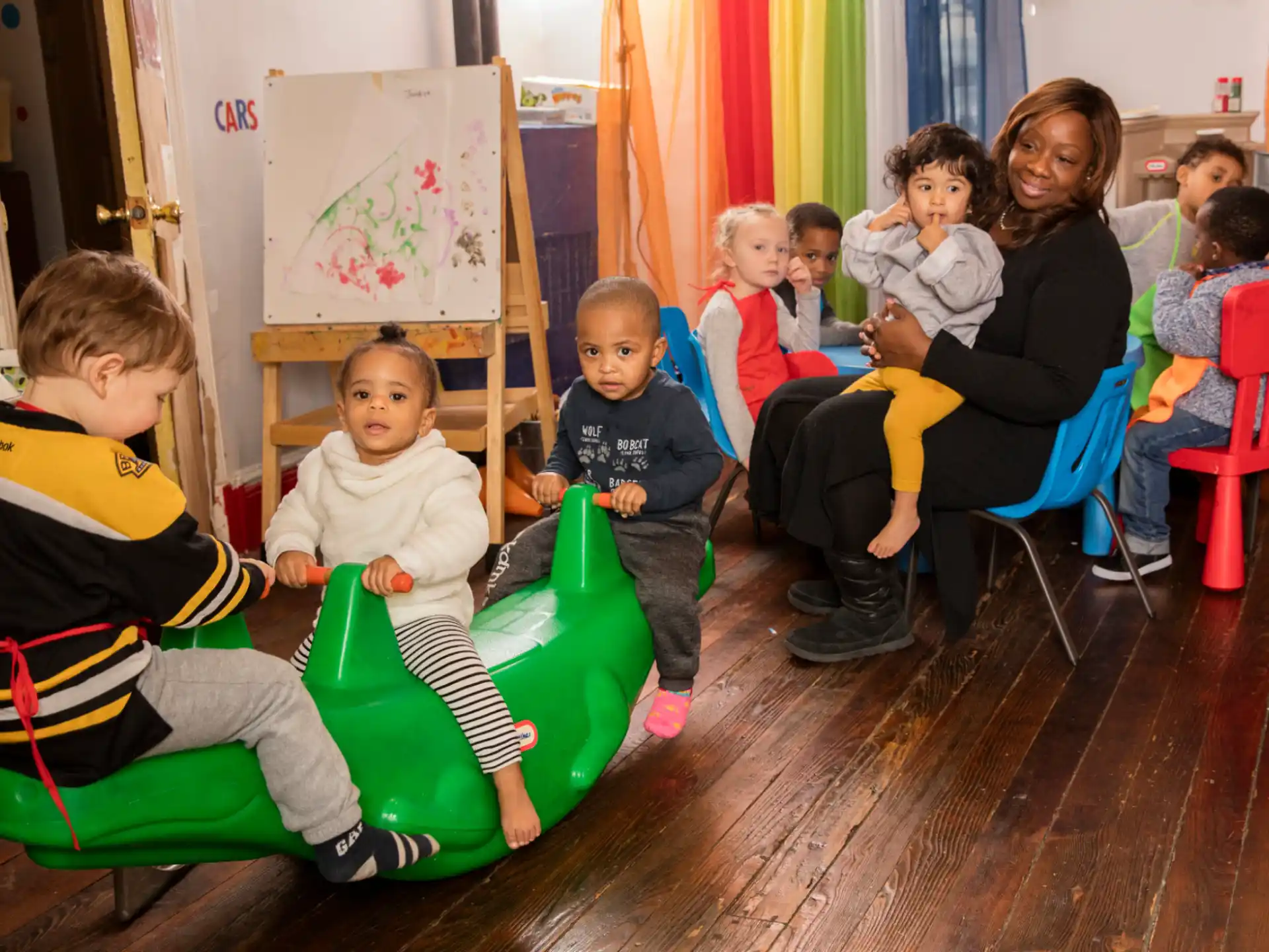 a group of children sitting in chairs