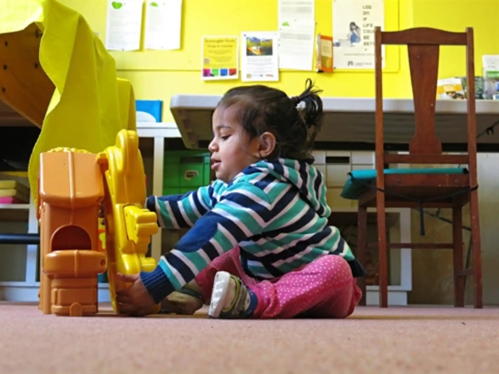 a little girl sitting on the floor