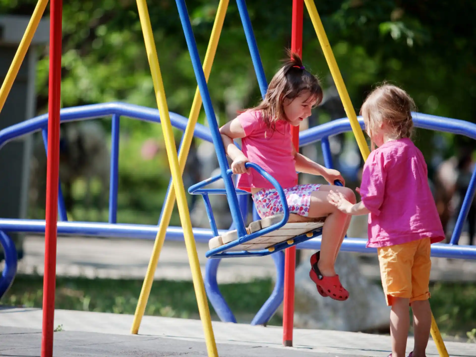 a couple of children playing on a playground
