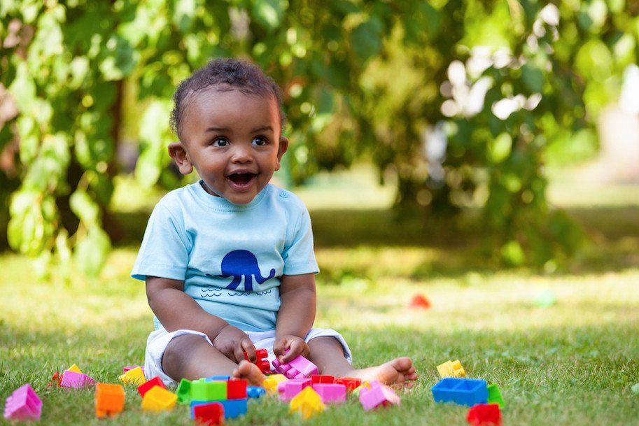 a baby sitting on grass