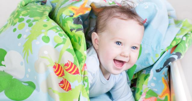 a baby lying on a blanket