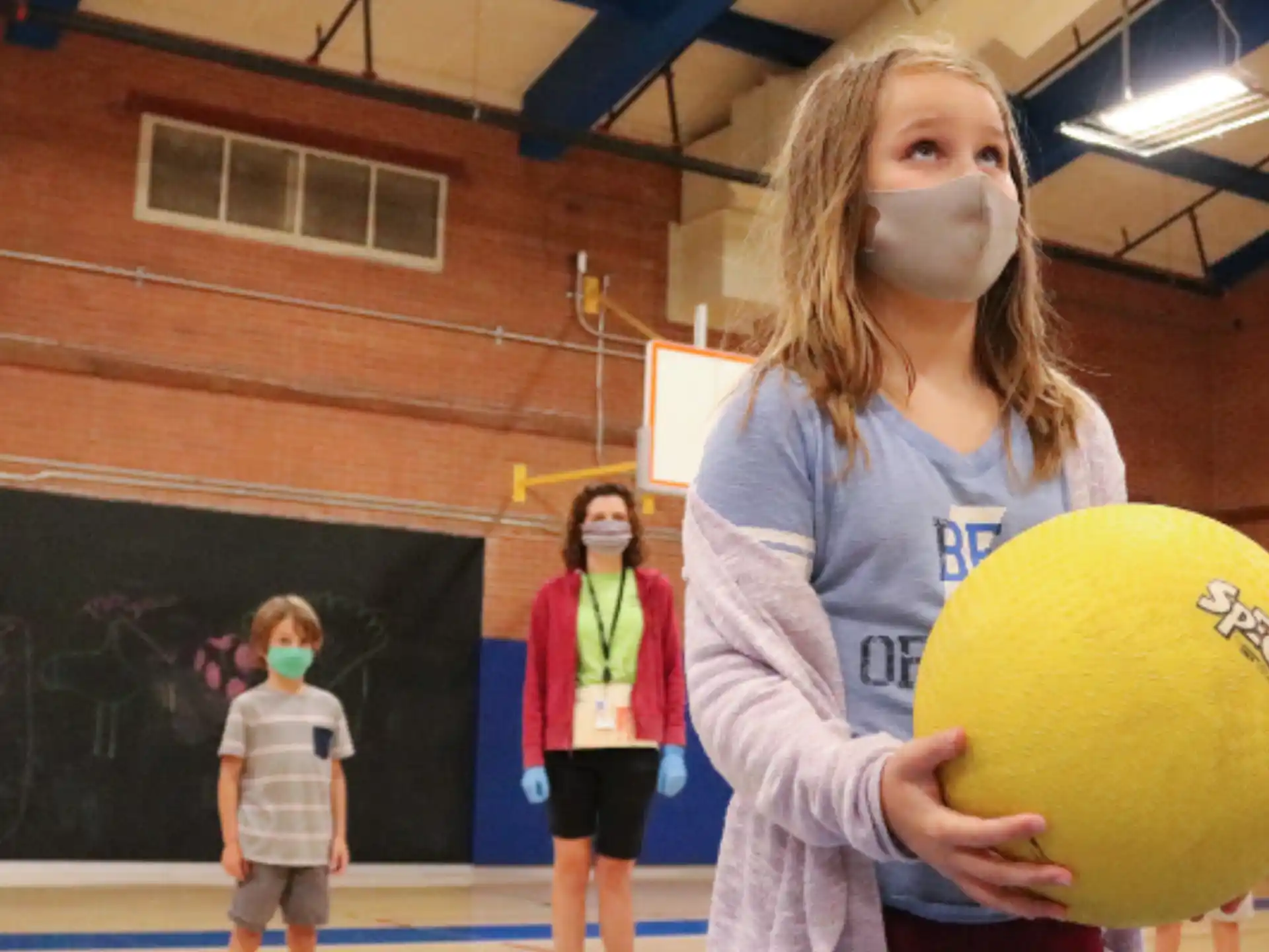 a woman holding a yellow ball