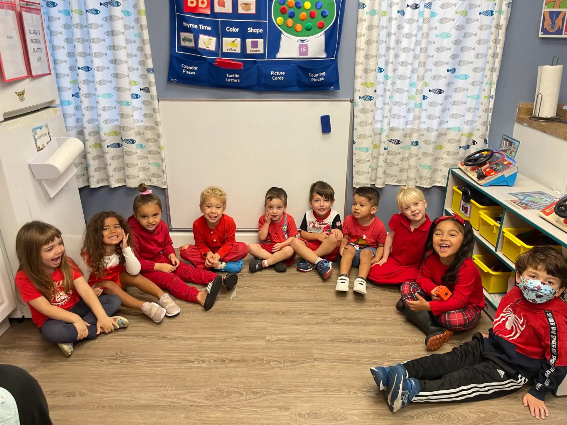 a group of children sitting on the floor in a room