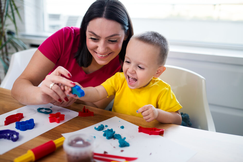 a person and a child playing with toys