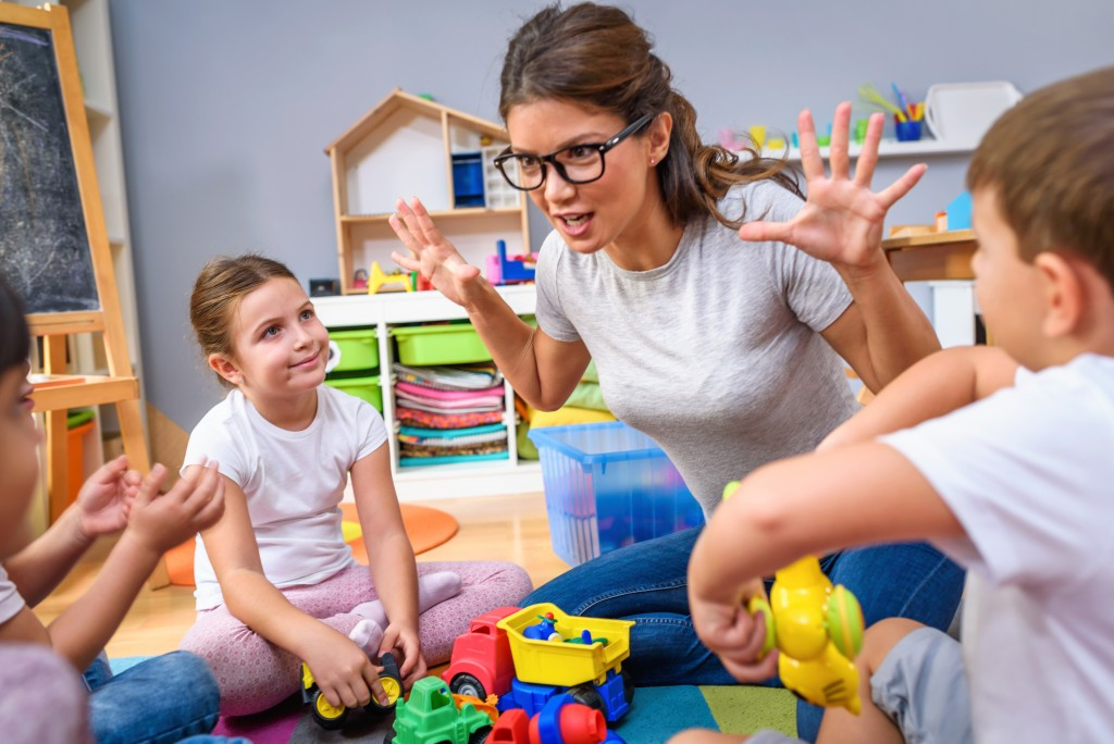 a person and children playing with toys