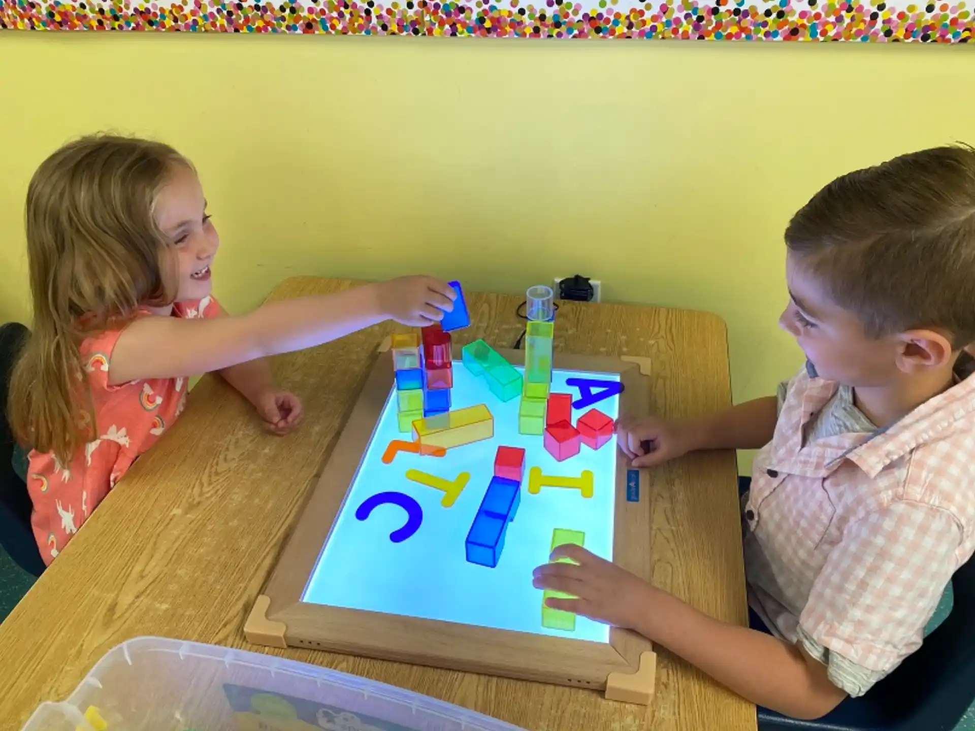 a boy and girl playing with toys
