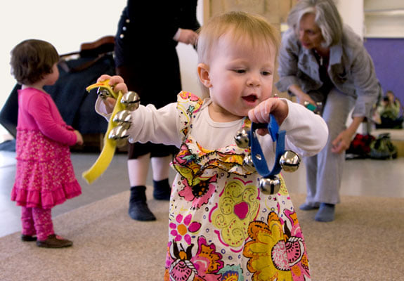 a baby holding a toy