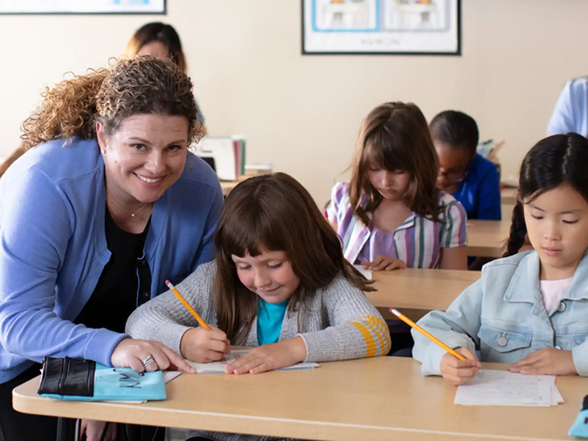 a person and several children sitting at a table