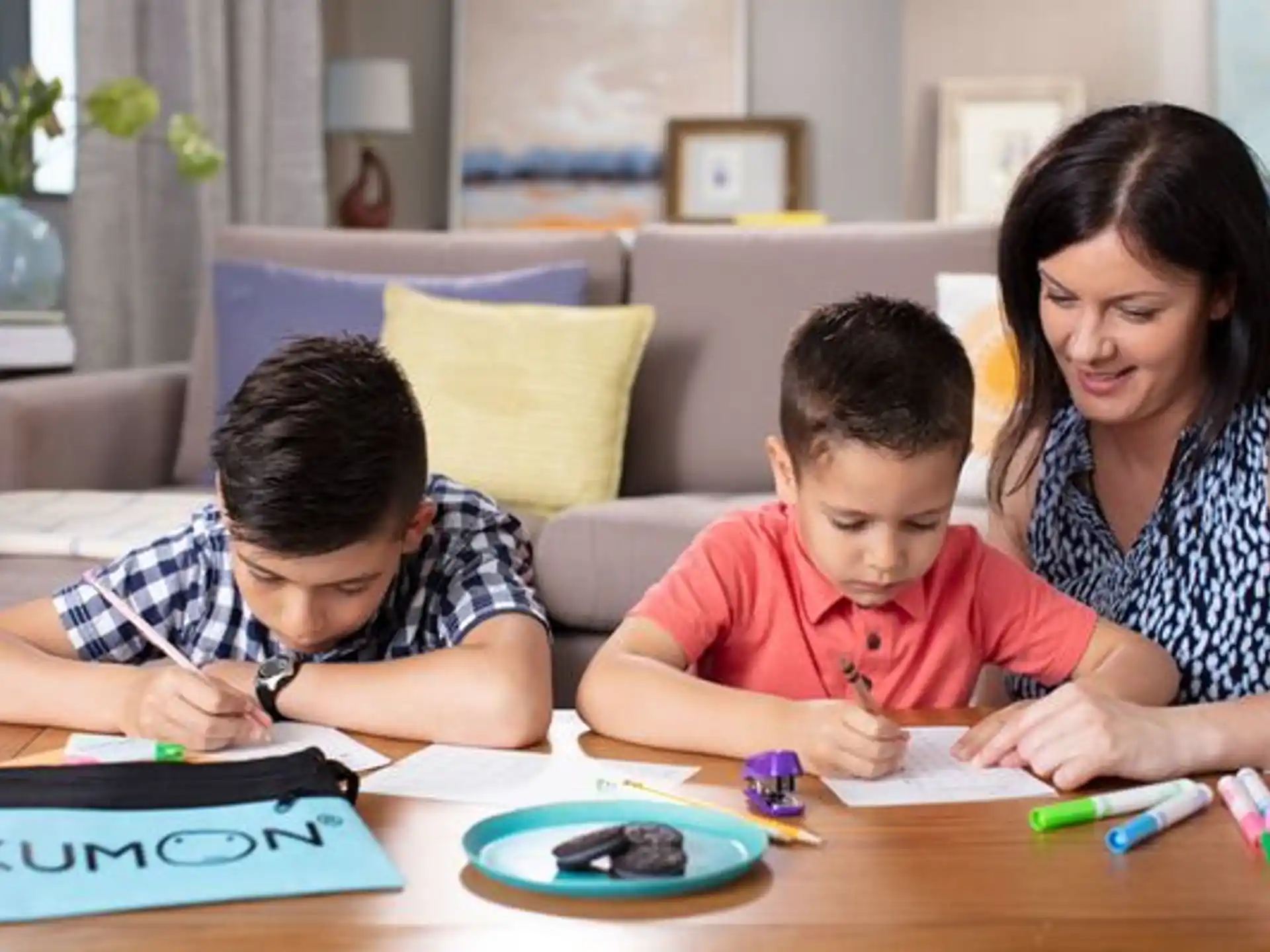 a person and two children sitting at a table