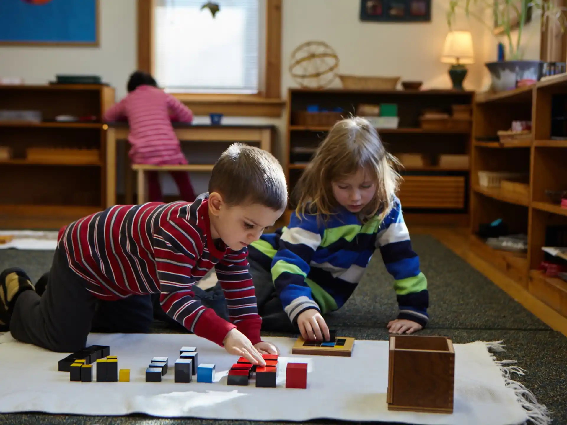 a boy and girl playing with toys