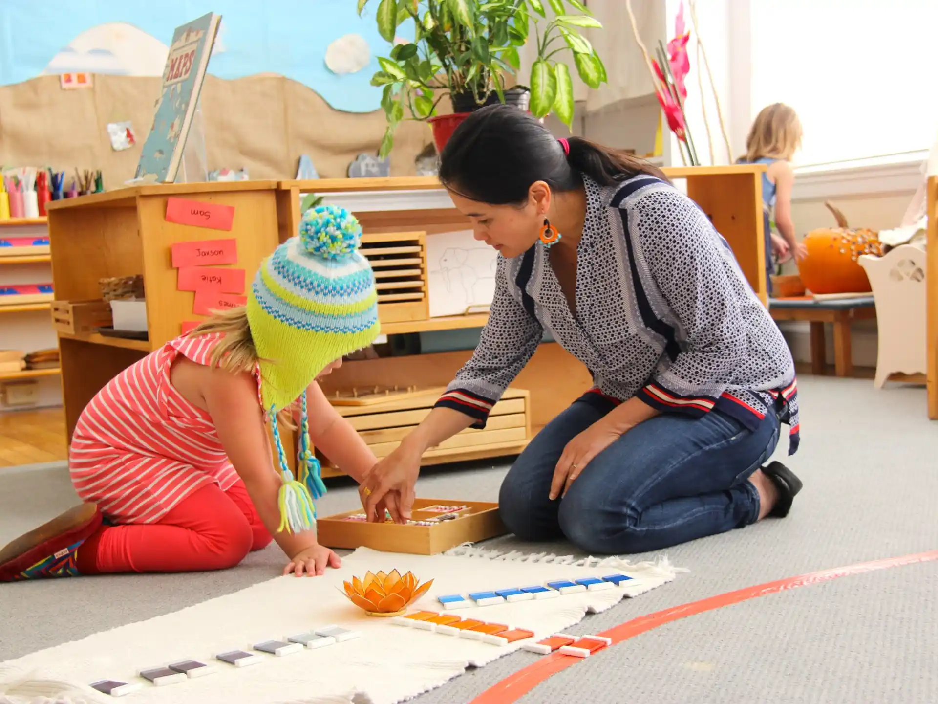 a person and a child playing with a toy