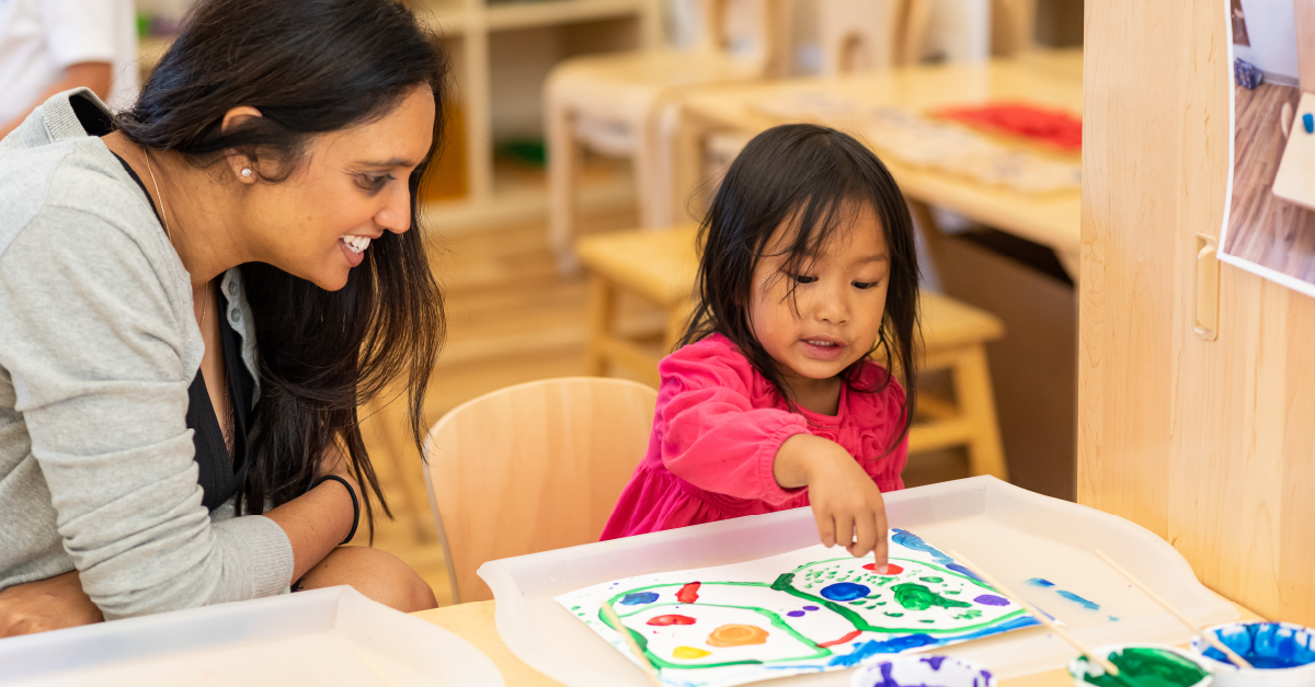 a person and a child looking at a book