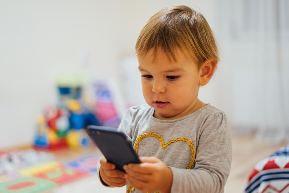 a baby playing with a phone