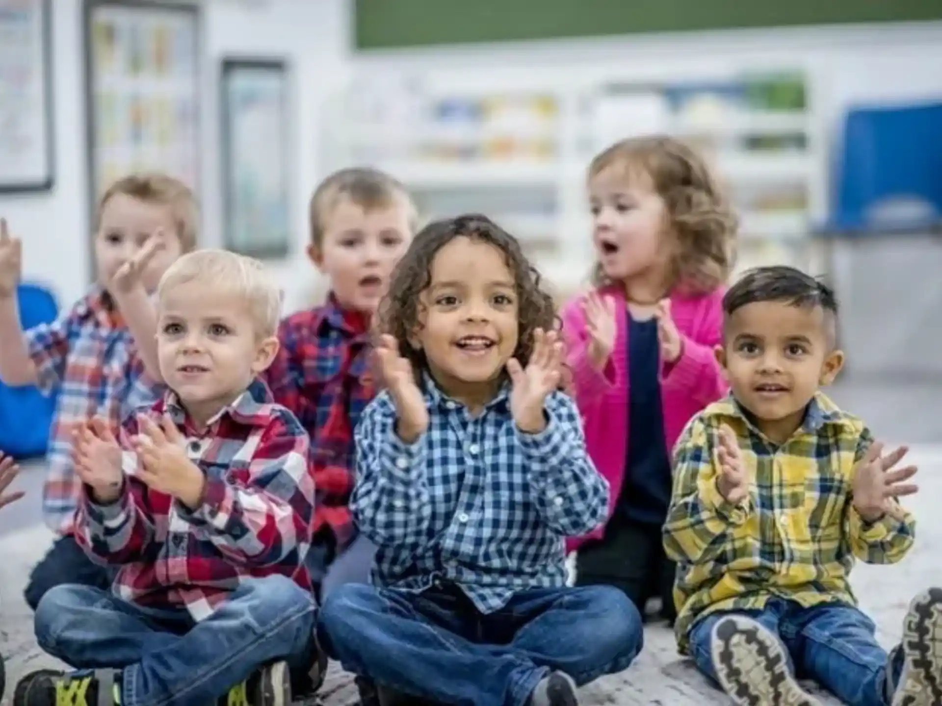 a group of children sitting on a bench