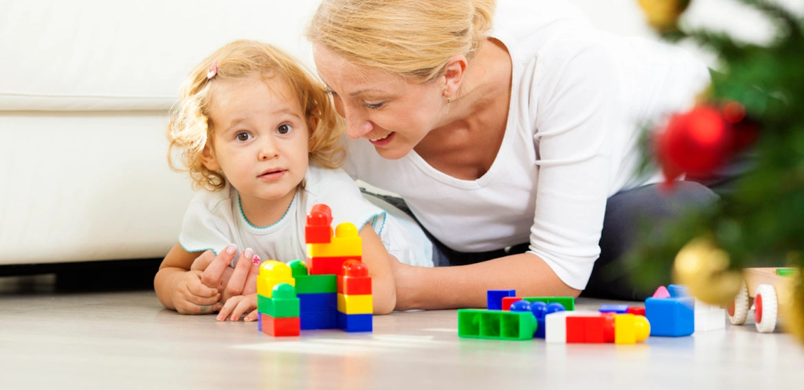 a person and a child playing with toys