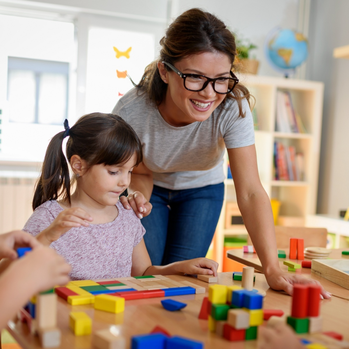 a woman and a child playing with toys
