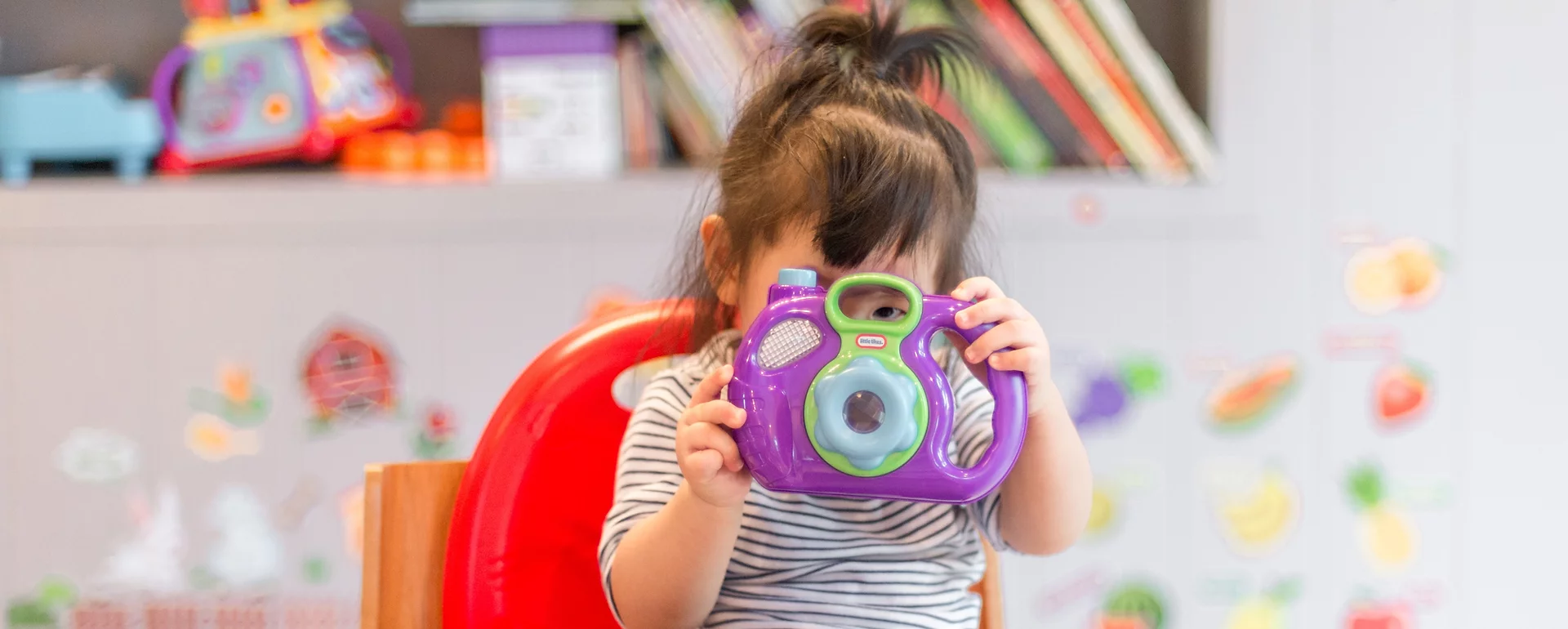 a girl holding a toy