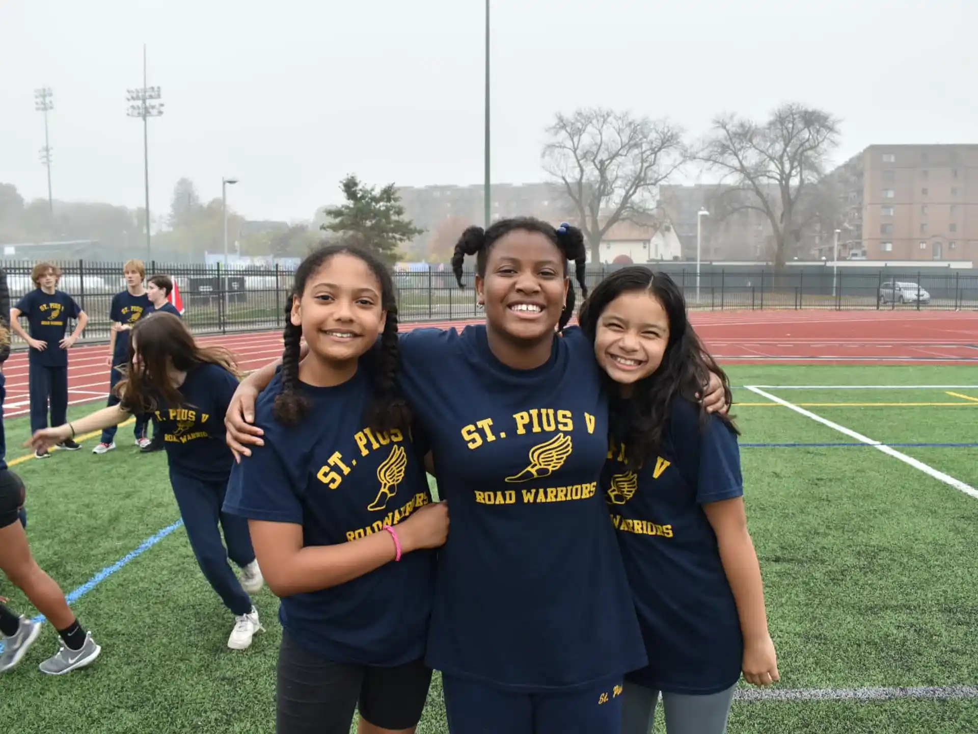a group of girls in blue shirts on a field