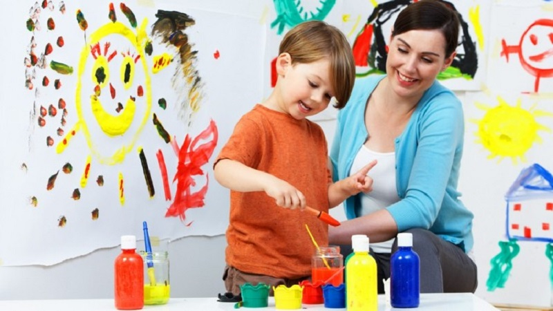 a person and a child painting