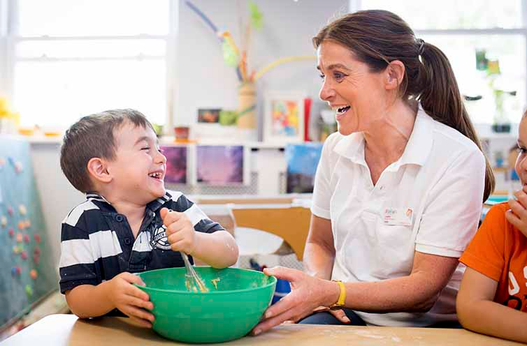 a woman and a boy eating from bowls