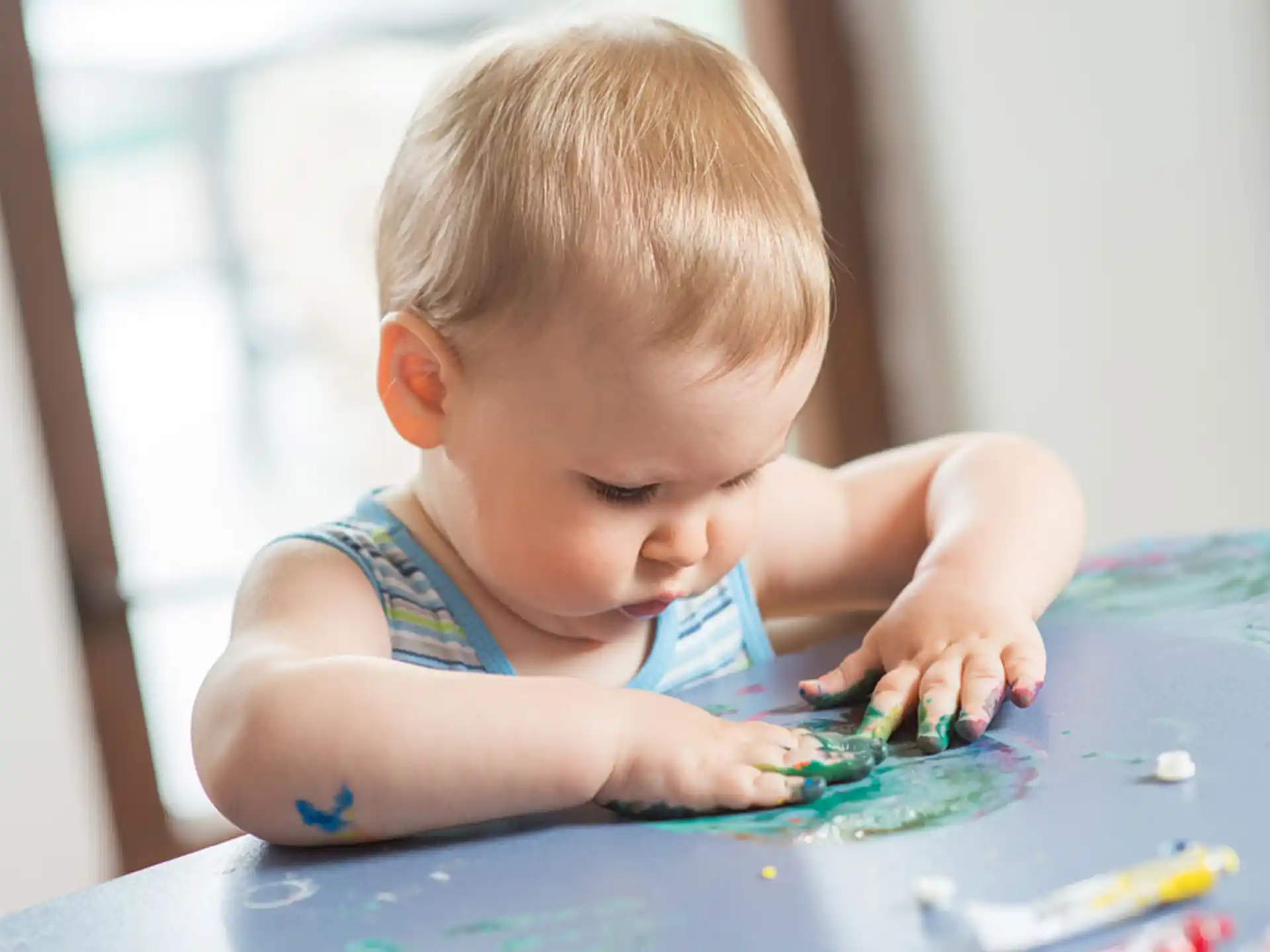 a baby playing with water