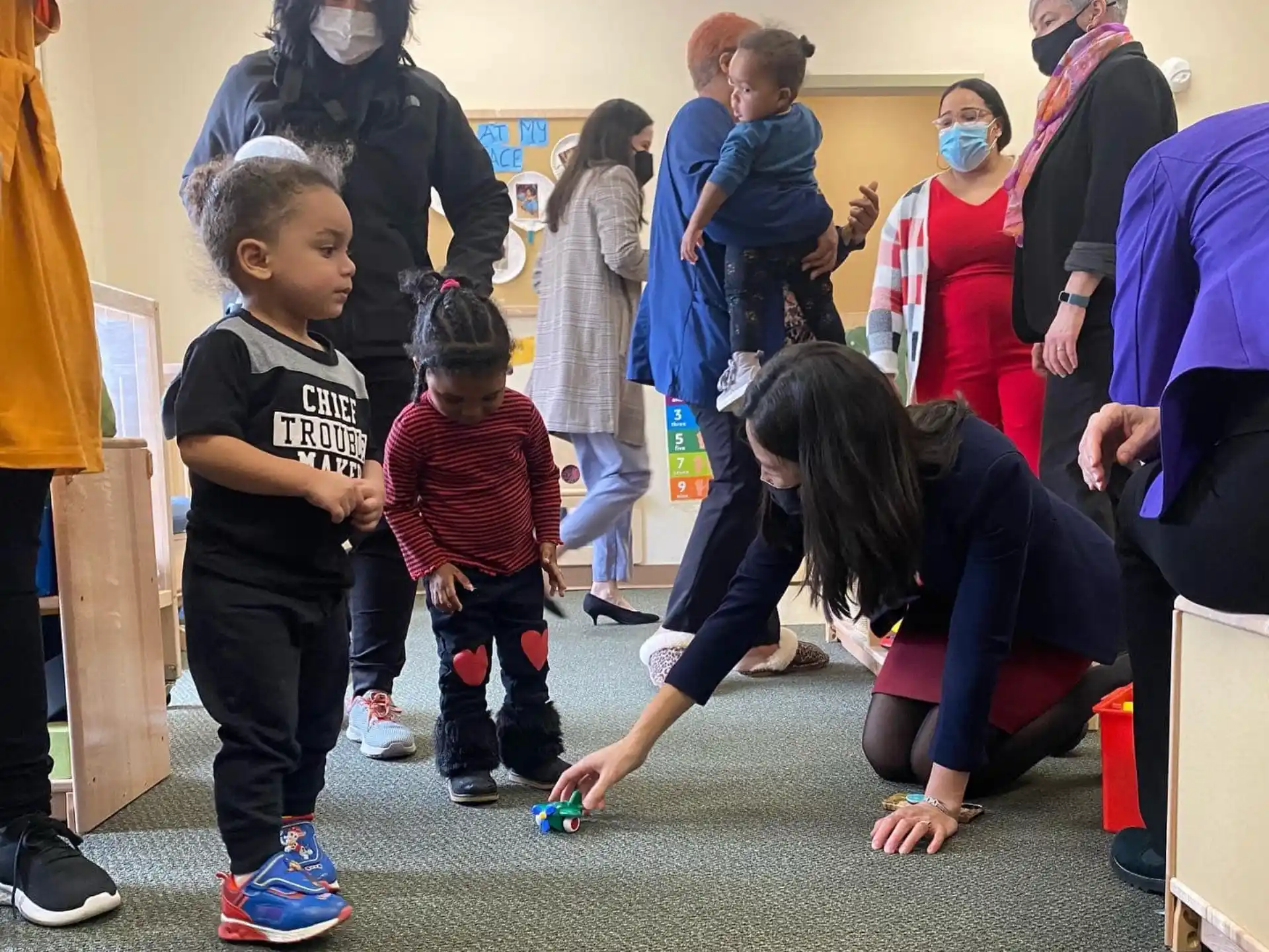 a person helping a child with a toy