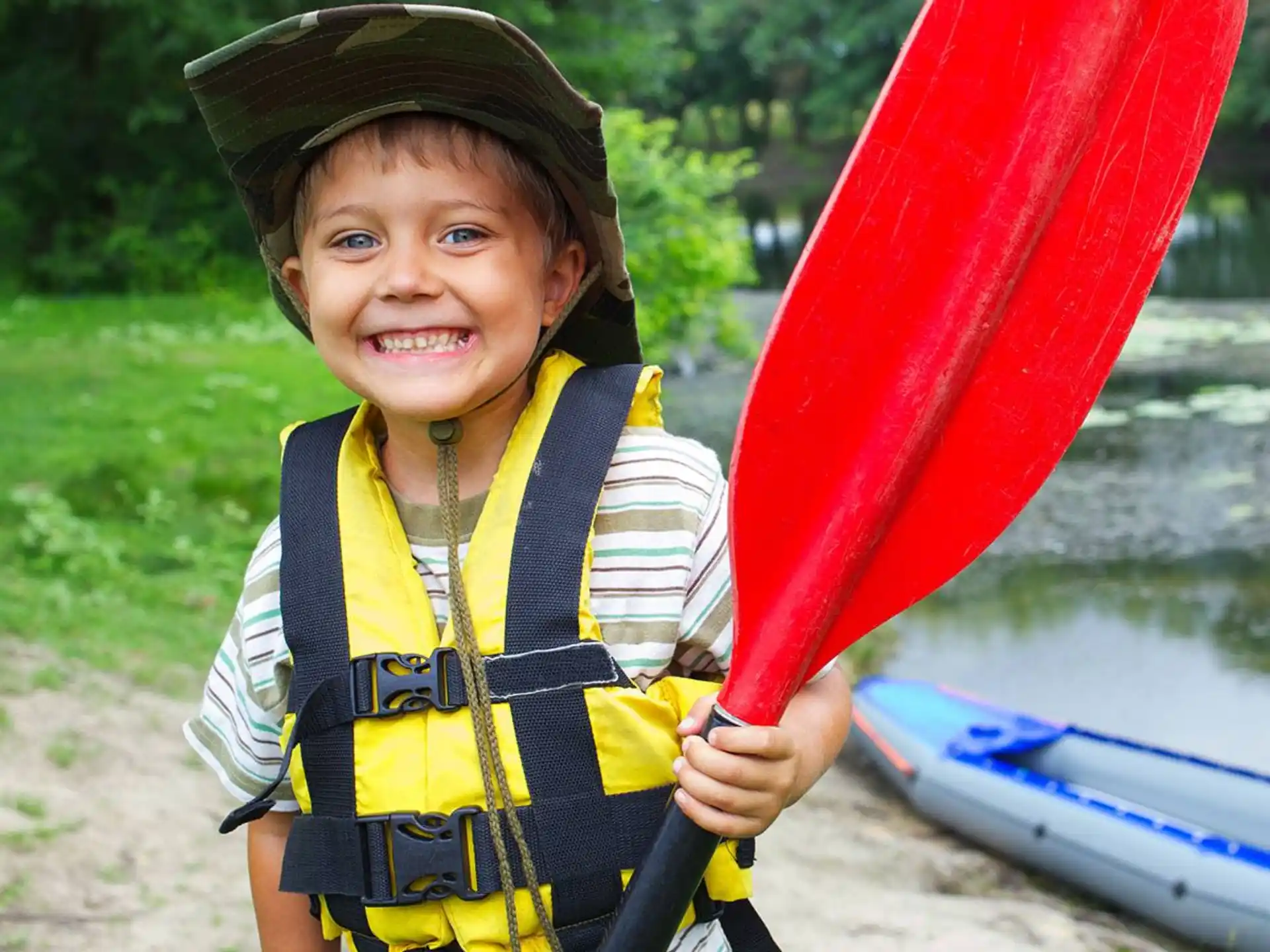 a child holding a red and yellow toy