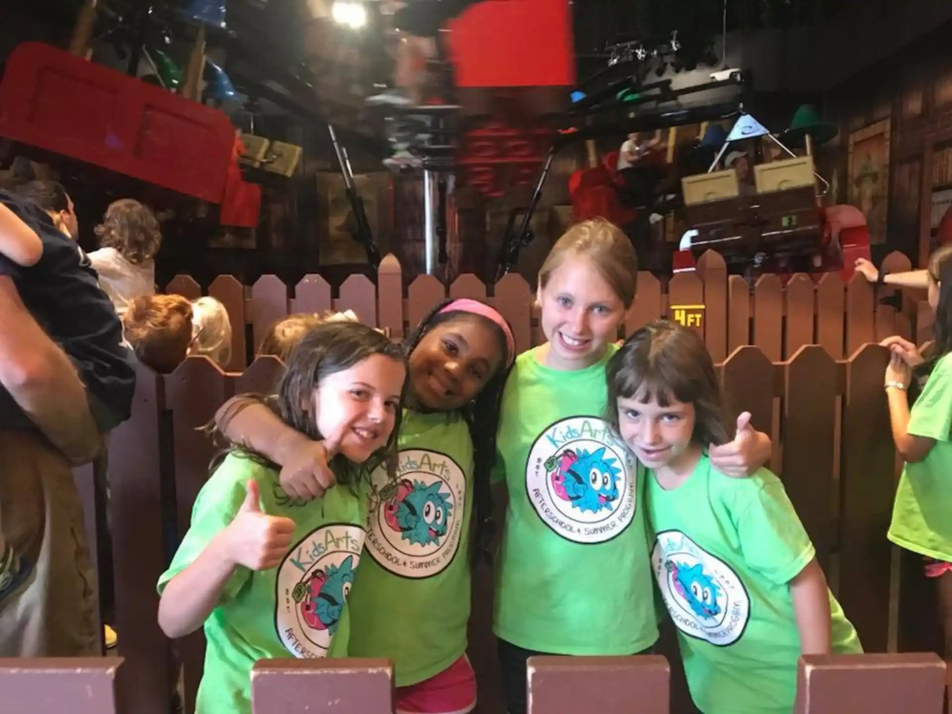 a group of kids wearing green shirts
