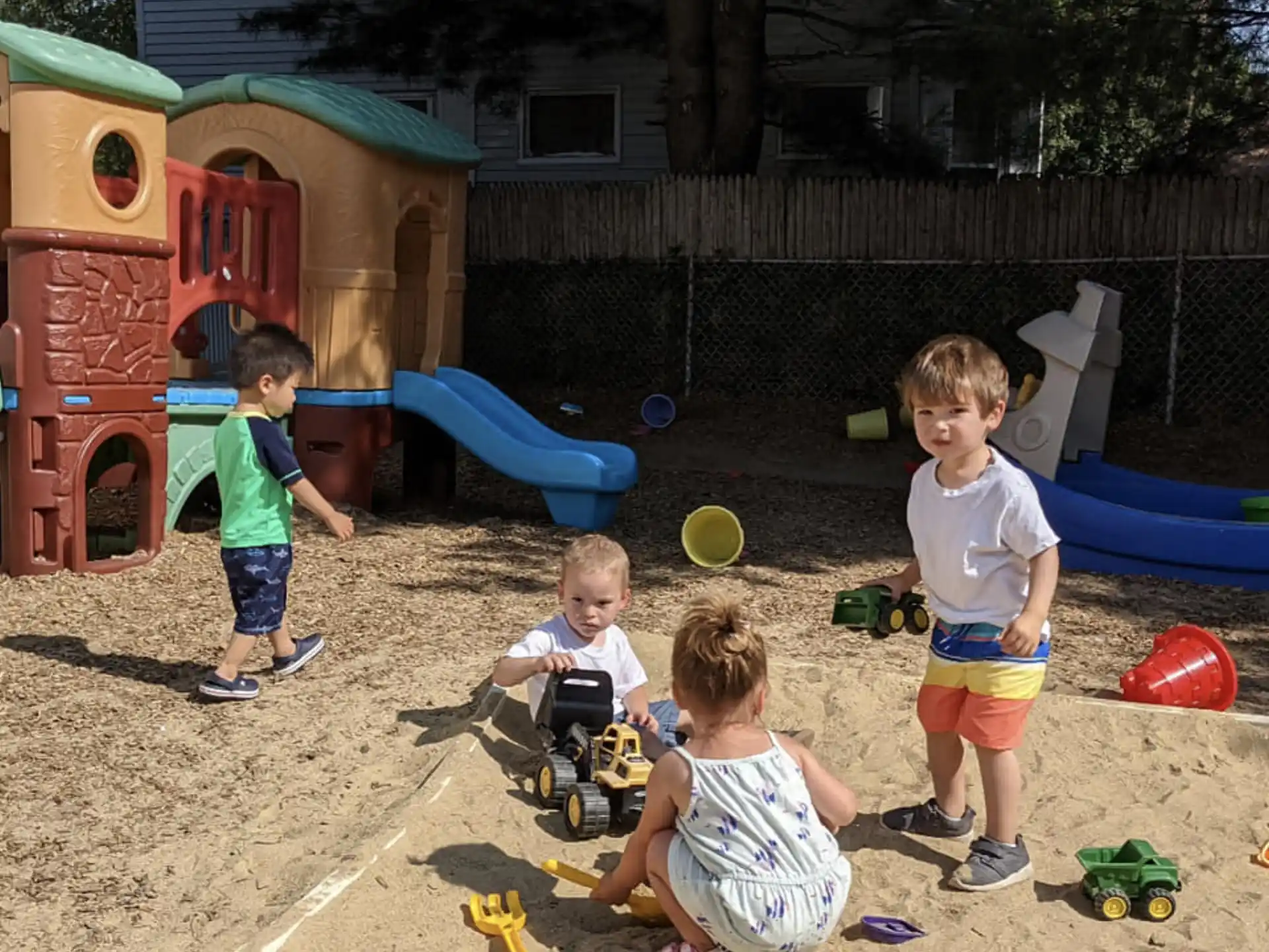 a group of kids playing in a sandbox