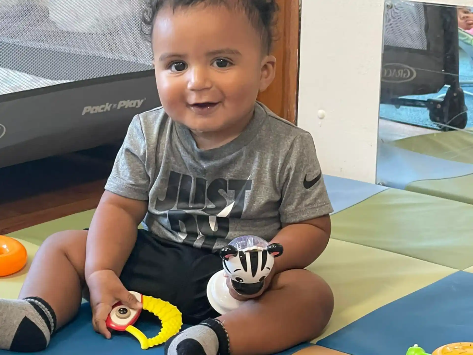 a baby sitting on the floor