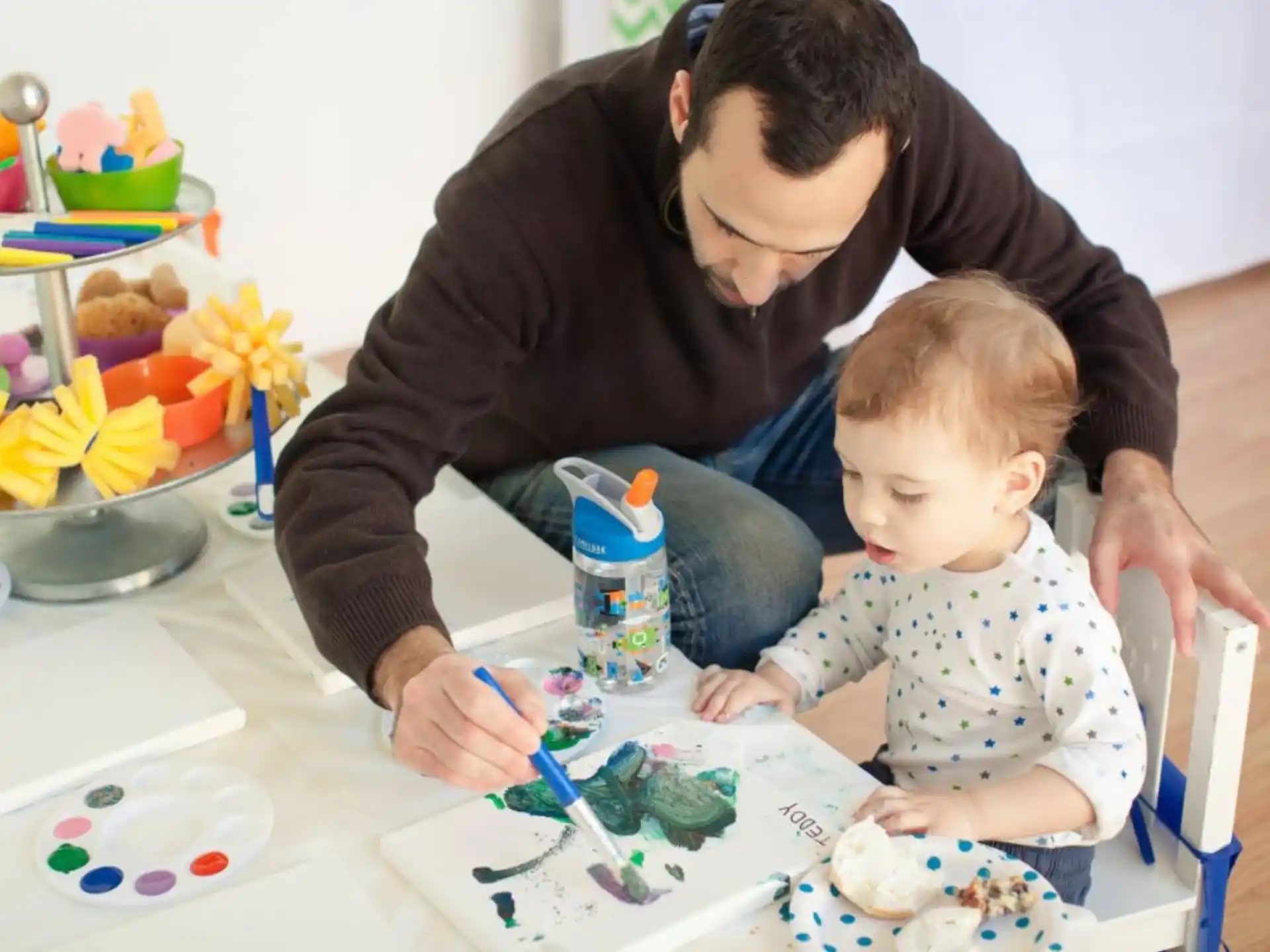a person and a baby painting