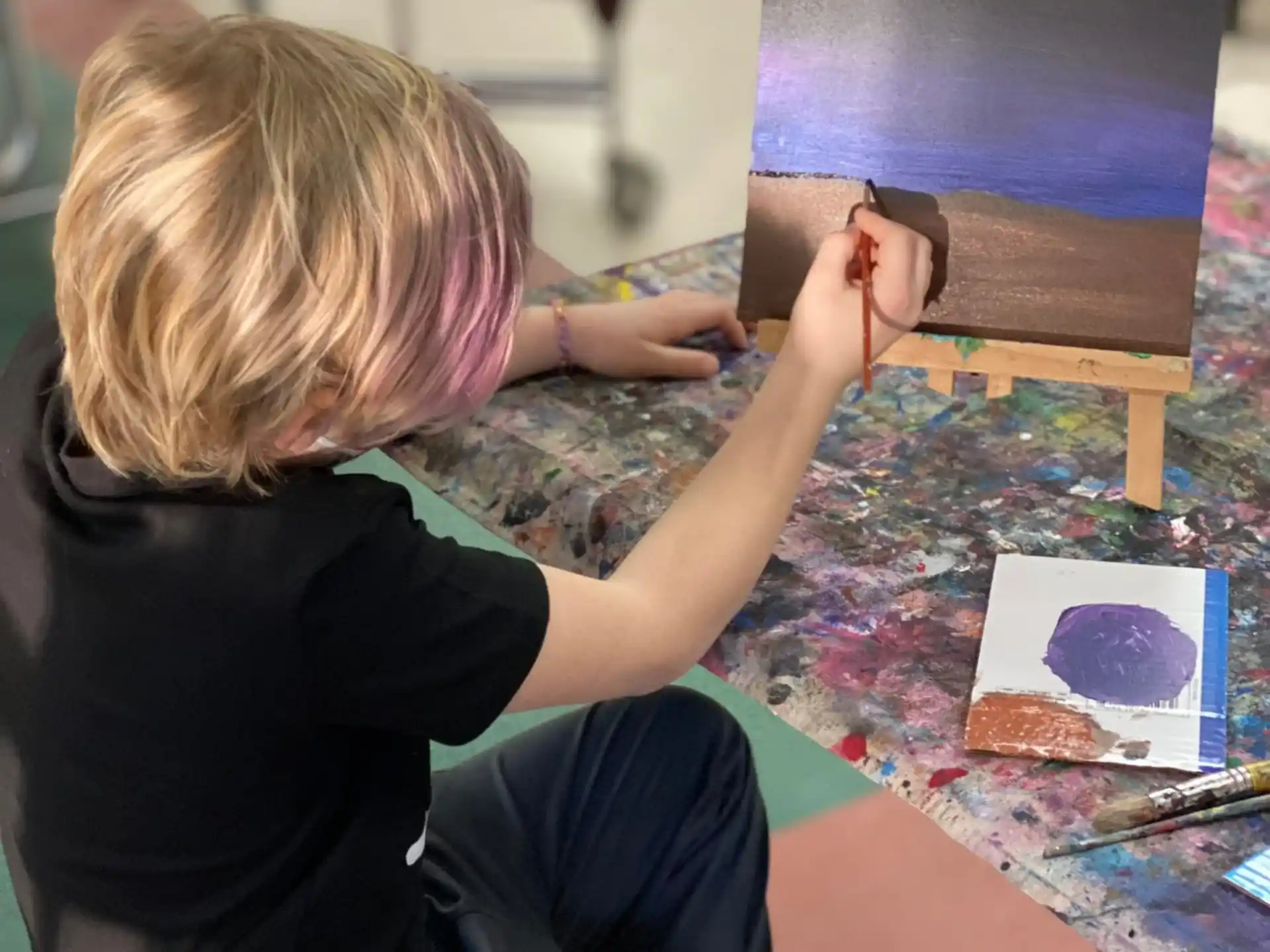 a child painting on a table