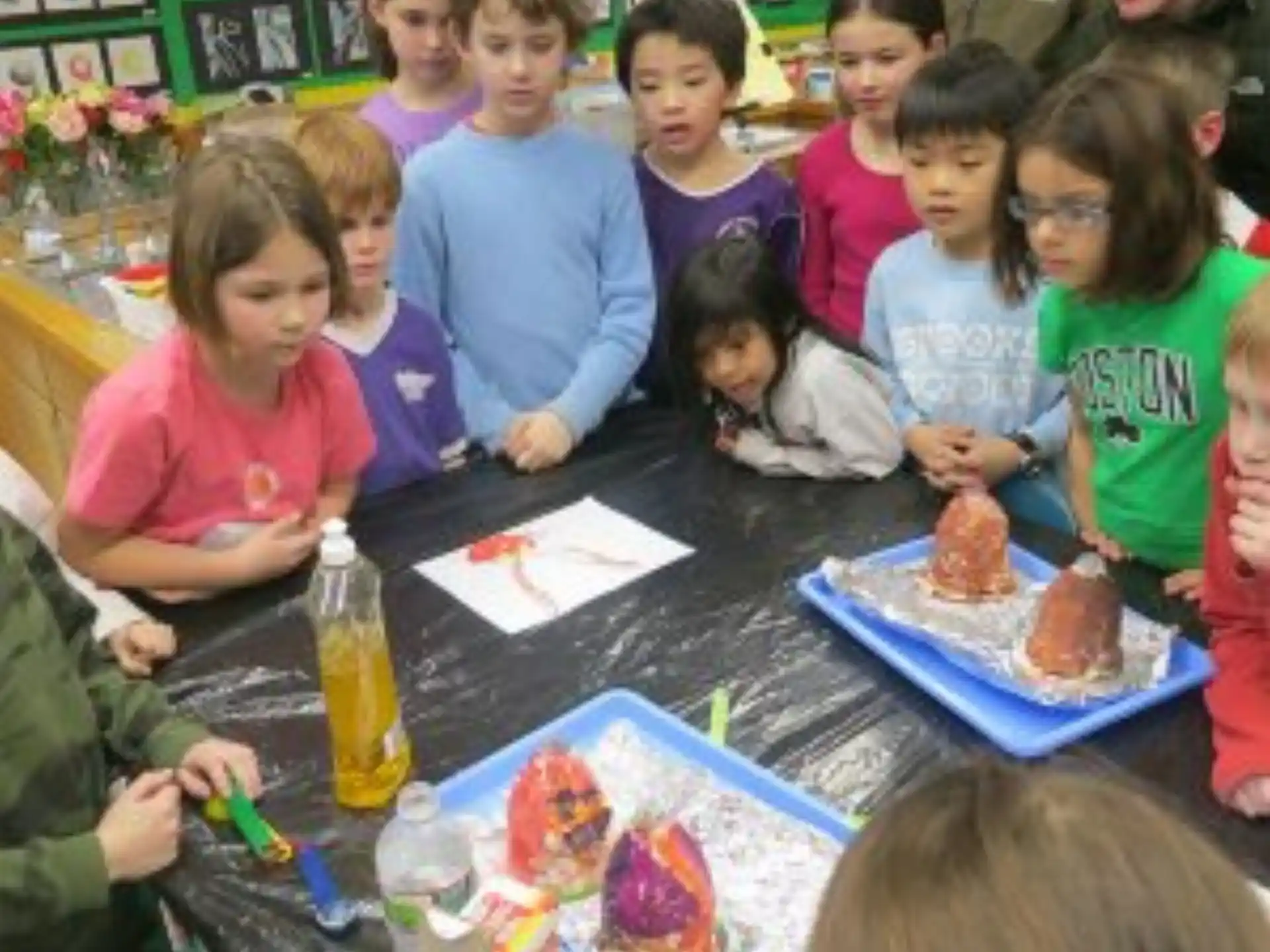 a group of children sitting at a table