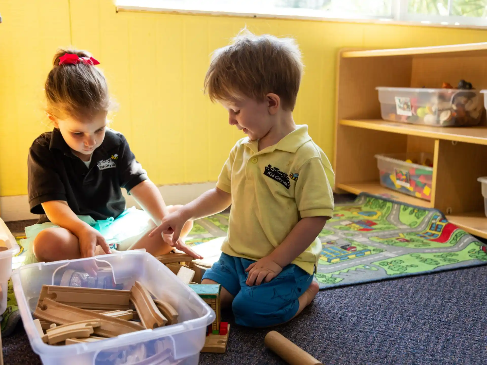 a couple of young boys playing with a toy