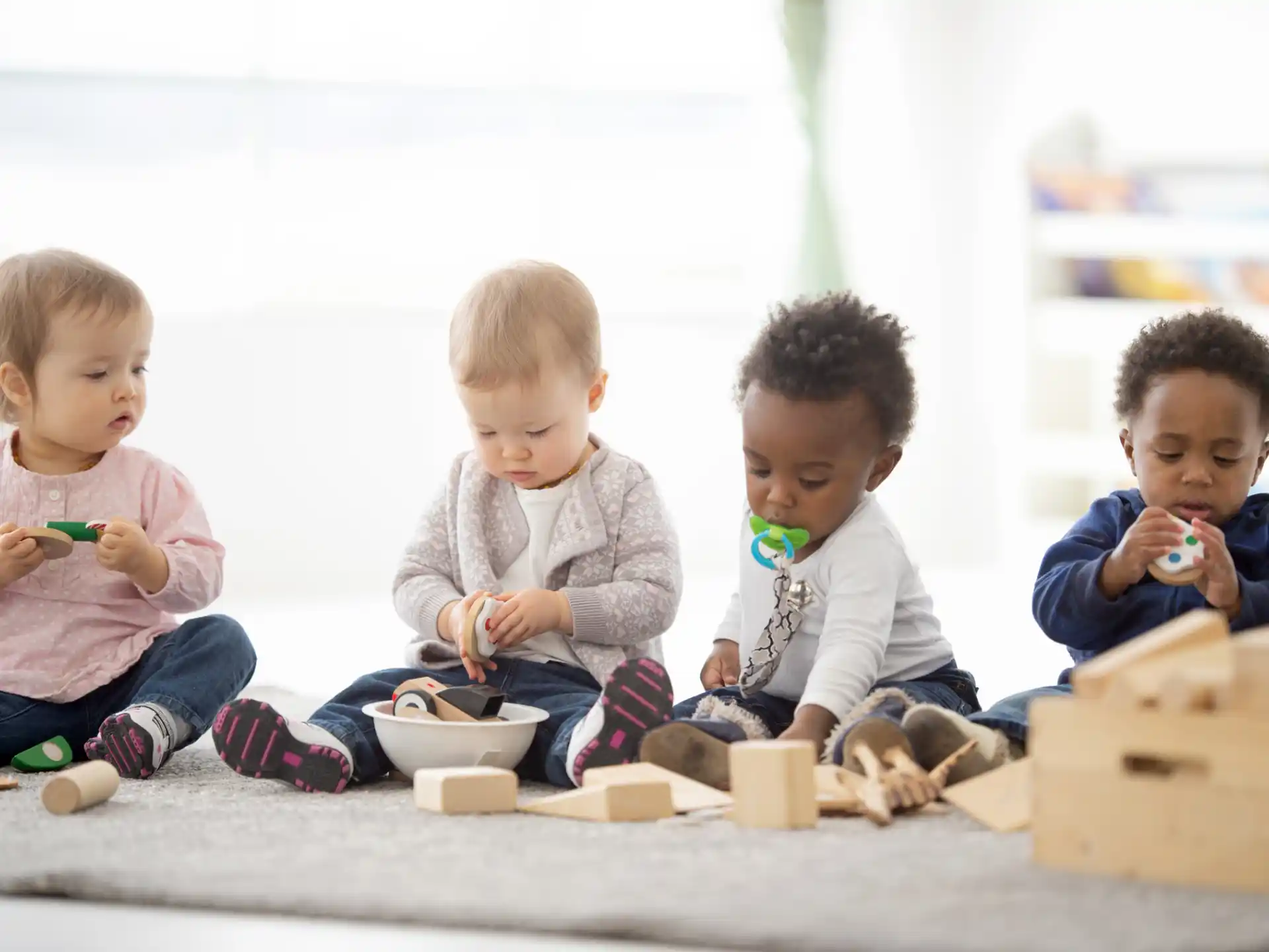 a group of kids sitting on the floor eating ice cream