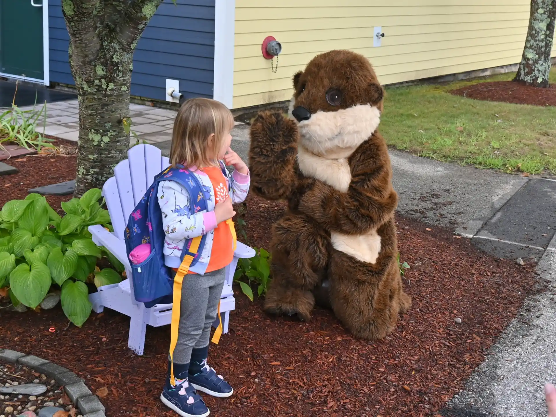 a child standing next to a person in a garment