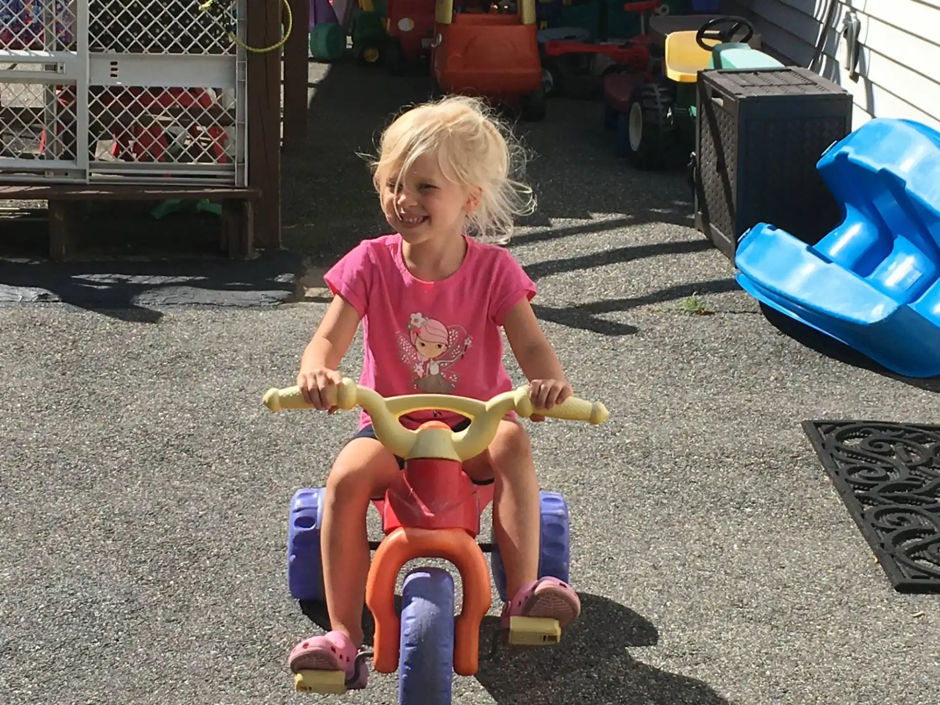 a girl riding a toy bike
