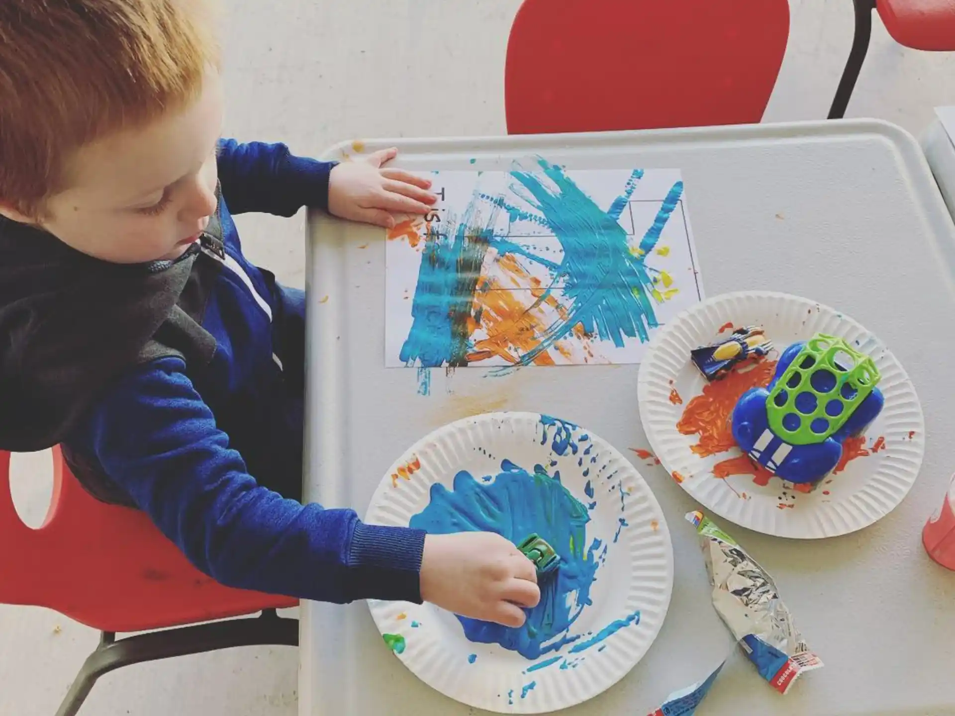 a child painting on a table