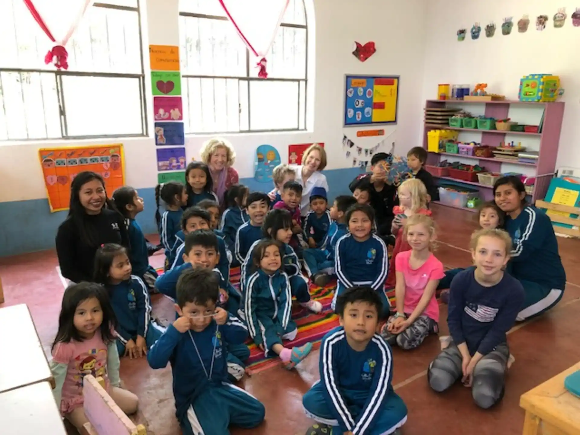 a group of children sitting in a classroom