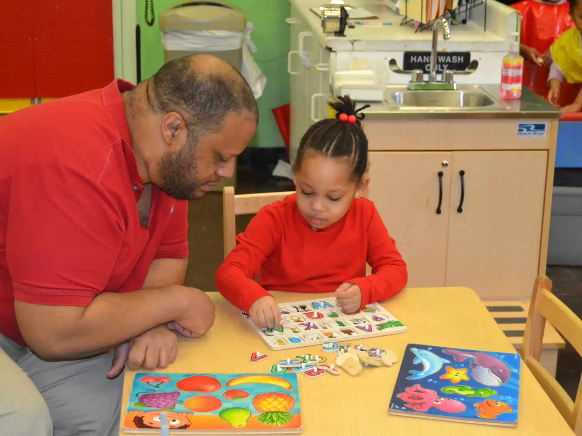 a man and a child playing a board game
