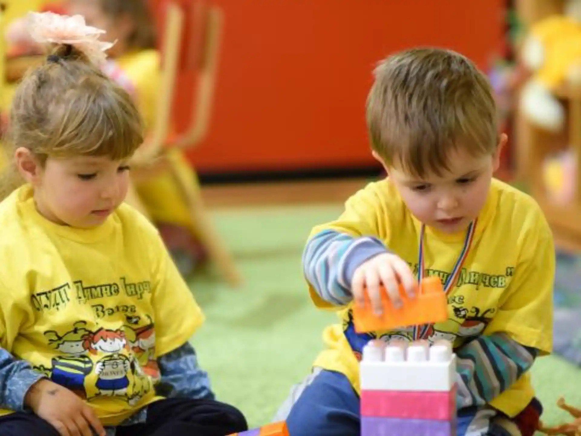 a couple of young boys sitting on the floor