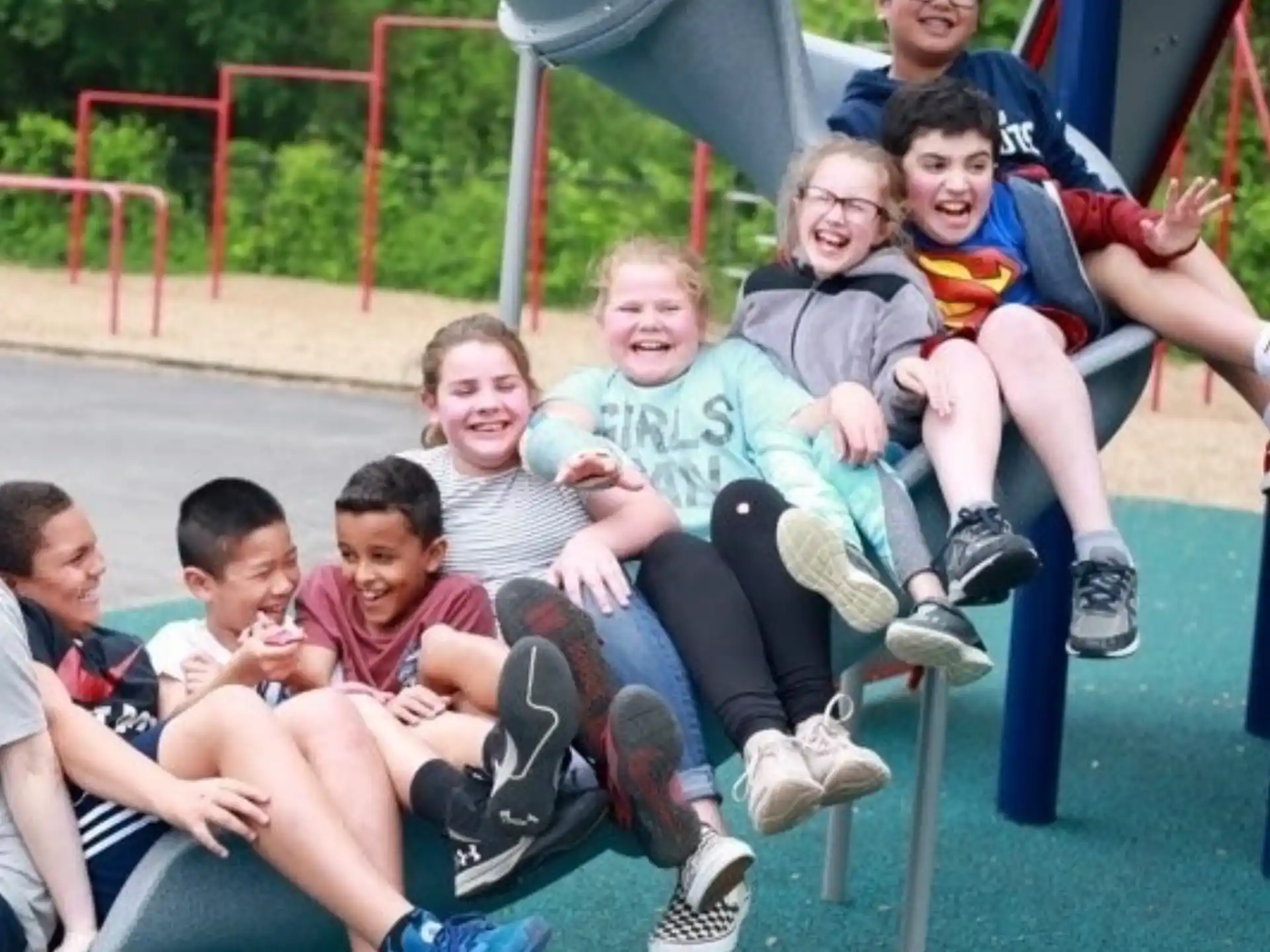 a group of kids sitting on a slide