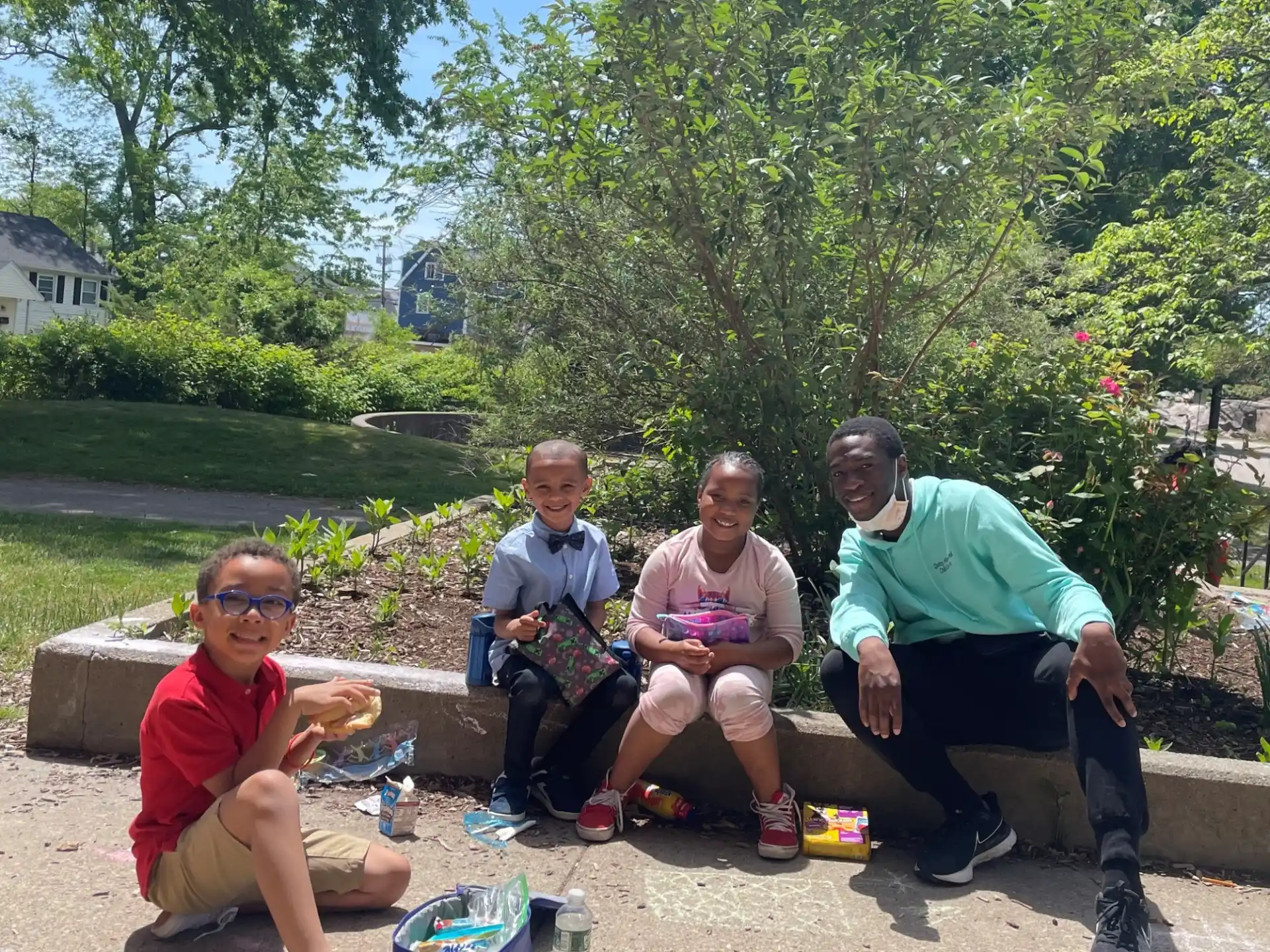 a group of people sitting on a bench outside