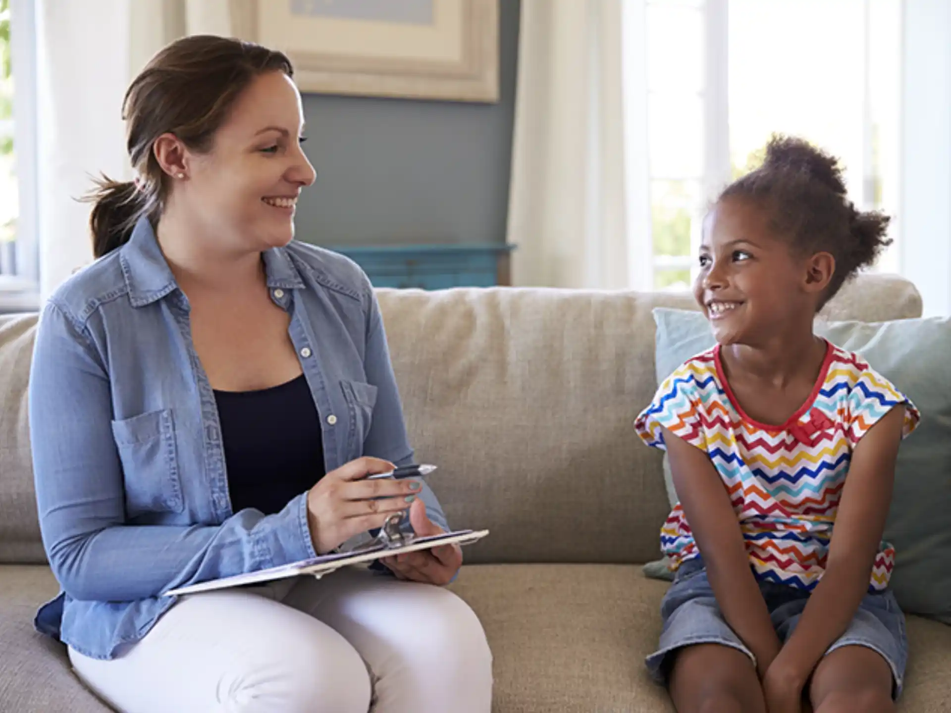 a woman and a child sitting on a couch