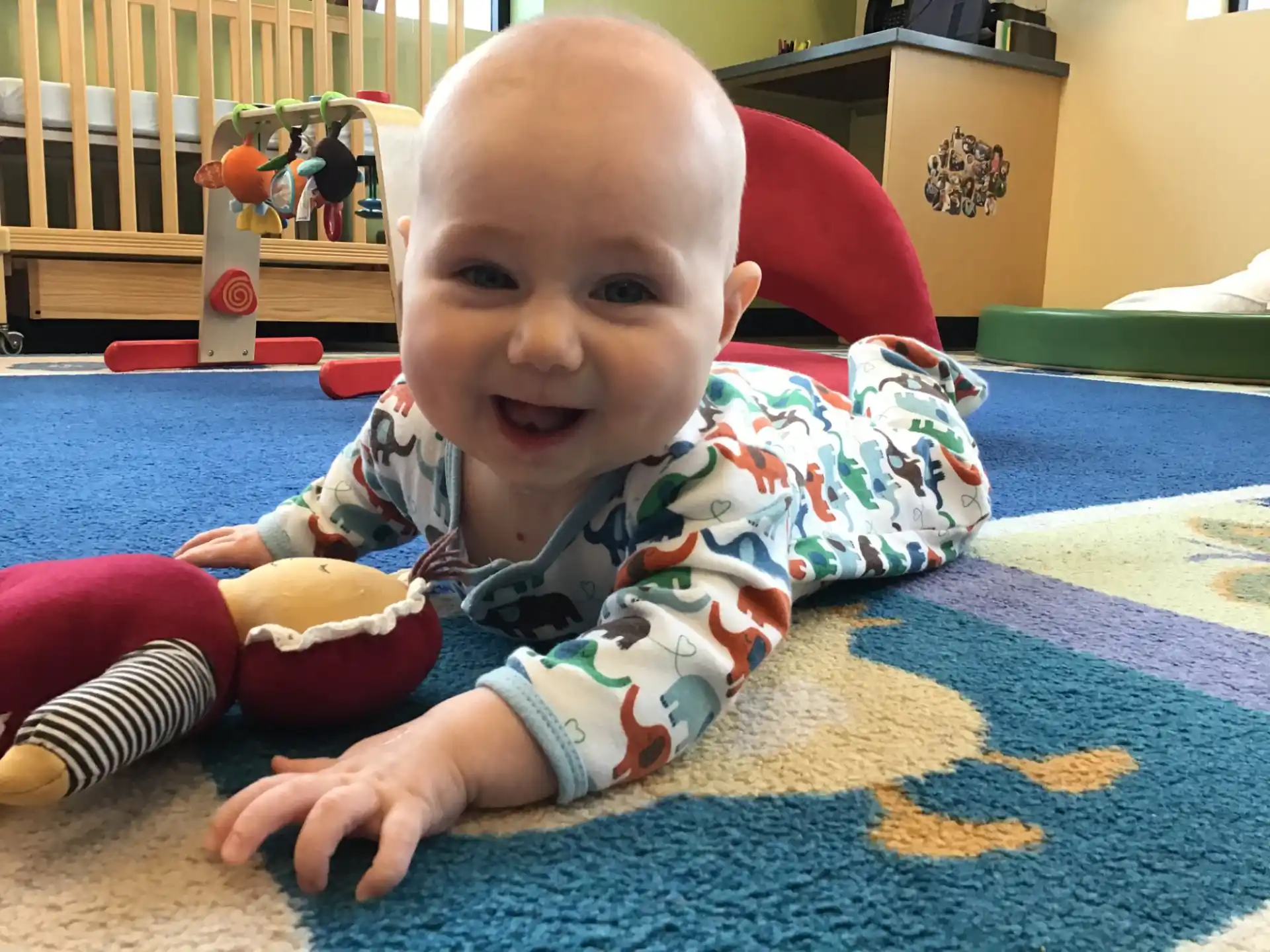 a baby sitting on a rug